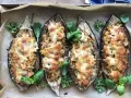 Fyra halverade auberginer fyllda med pasta och ost, ett läckert aubergine recept. Garnerade med färska örter.