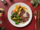 En festlig tallrik med saftig biff, rostade potatisklyftor, grönsaker och en krämig sås. Perfekt glutenfri mat för högtider.