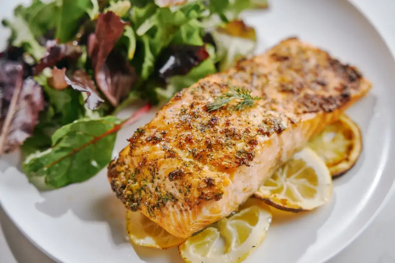 En saftig laxfile i airfryer, kryddad med dill och serverad med citronklyftor och en fräsch sallad. En perfekt och hälsosam måltid.